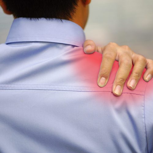 The picture shows office workers using their hands to touch their shoulders with pain and injury. Healthcare and medical concept.